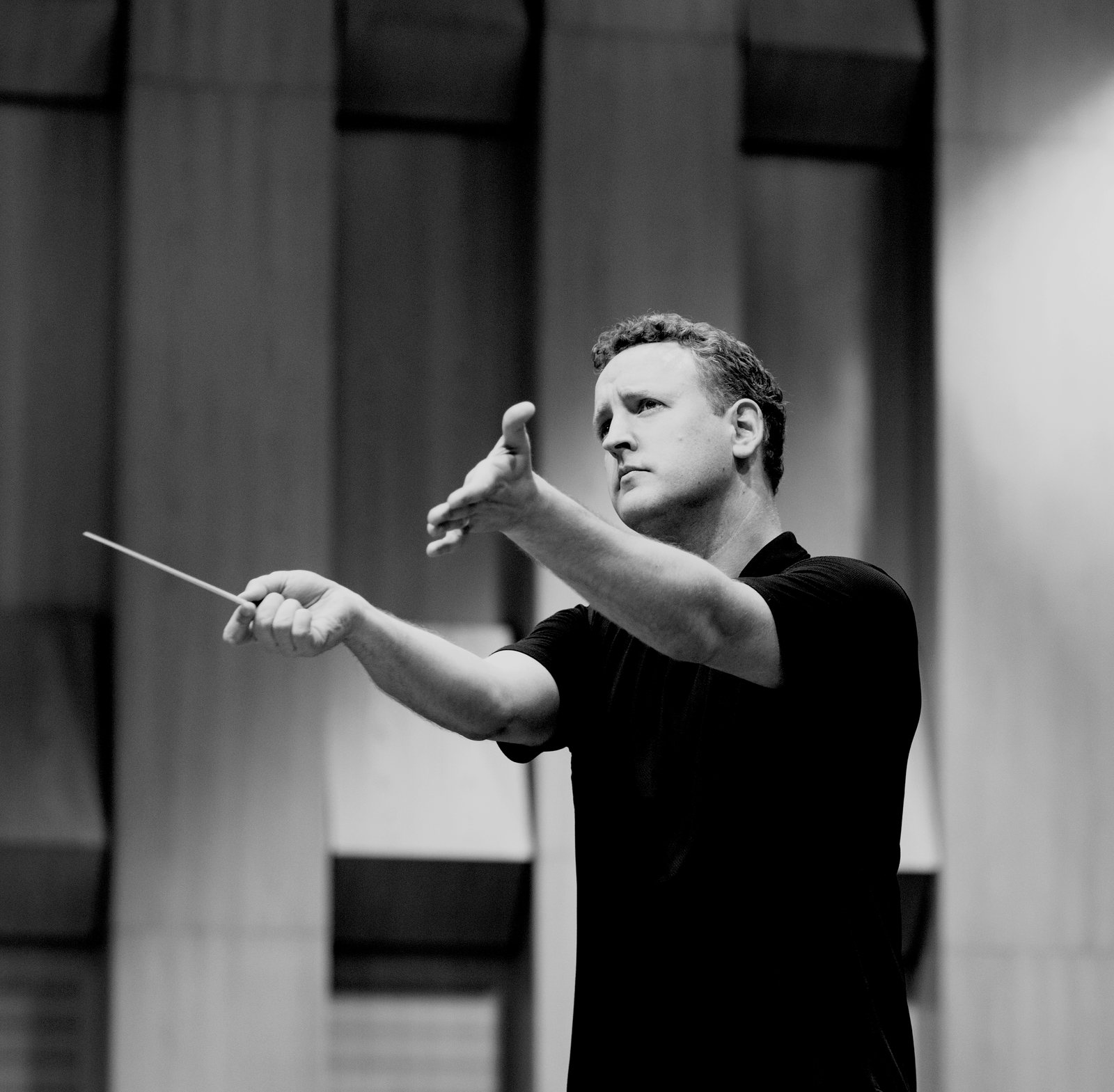 Michael Francis conducting, baton extended