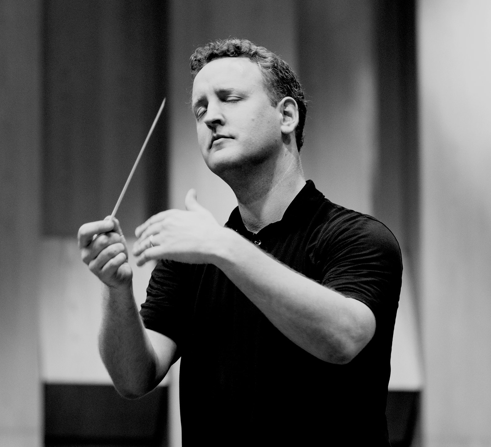 Michael Francis conducting, mid-gesture