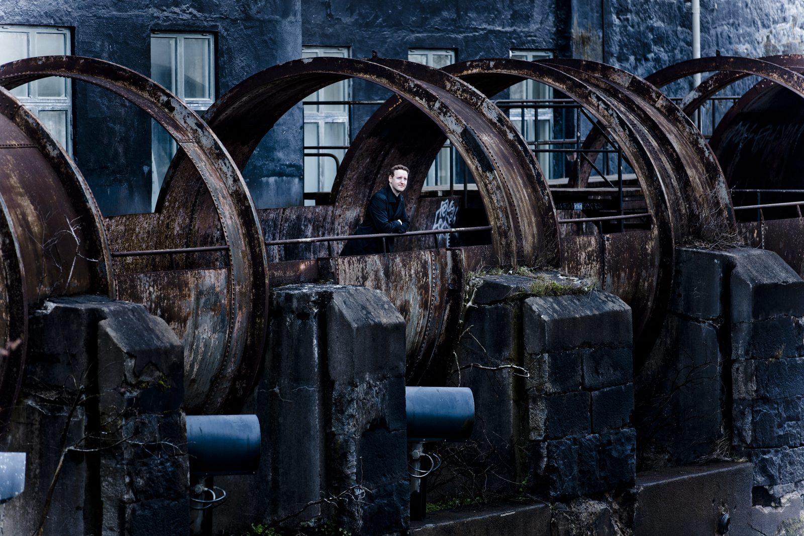 Michael Francis among large industrial wheels