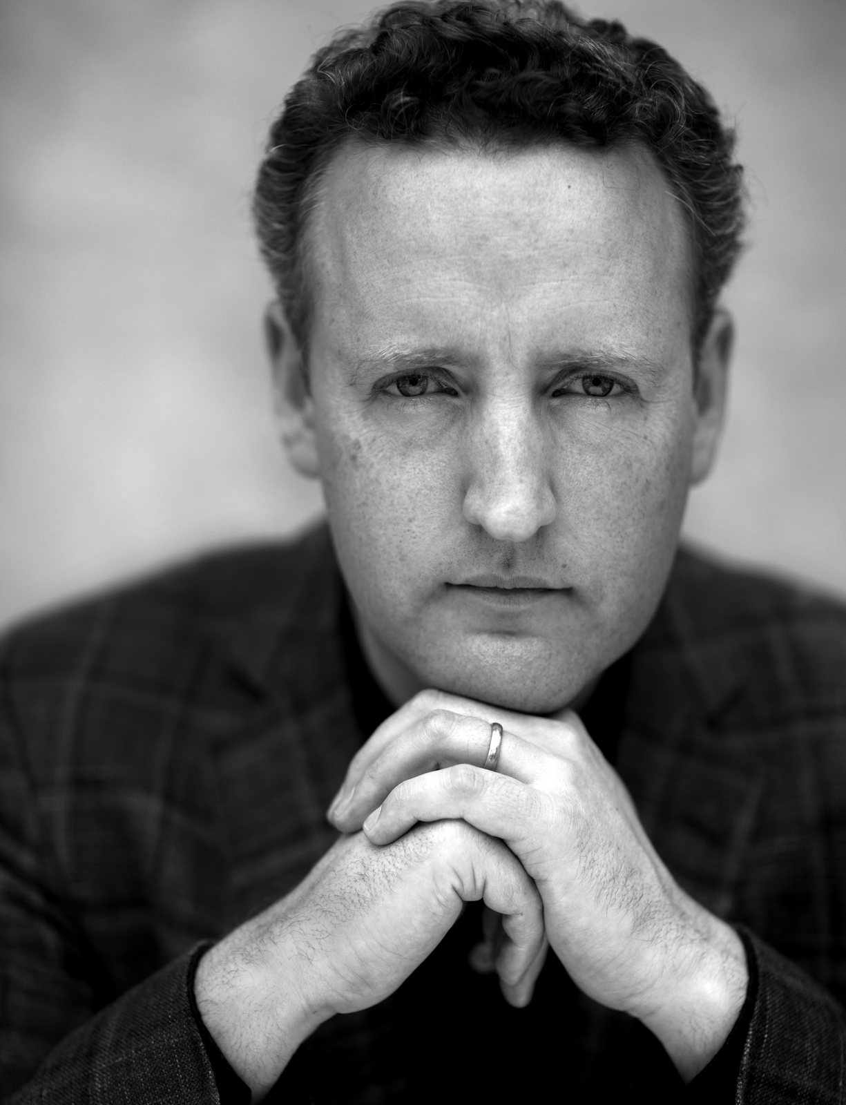 Black-and-white portrait of Michael Francis, hands clasped